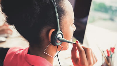A call centre agent speaking on the phone
