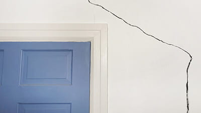 A crack running along a wall at home