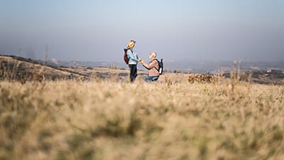 Senior man proposing to his partner in nature.