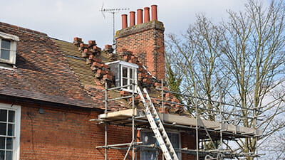 A house with scaffolding being retiled