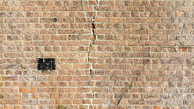 Exposed brickwork with a crack running down the middle