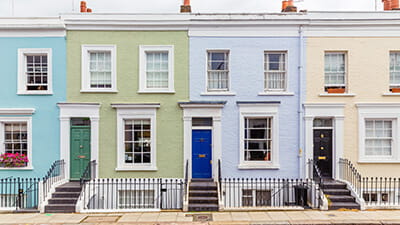 A row of multi-colored townhouses in Notting Hil