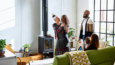 A grandmother entertaining her family while holding her granddaughter