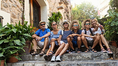 Multi generation family sightseeing beautiful town of Valldemossa, Majorca, Spain