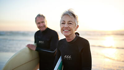 Senior married couple coming from surfing