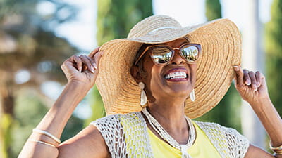 Senior woman smiling and wearing sunglasses