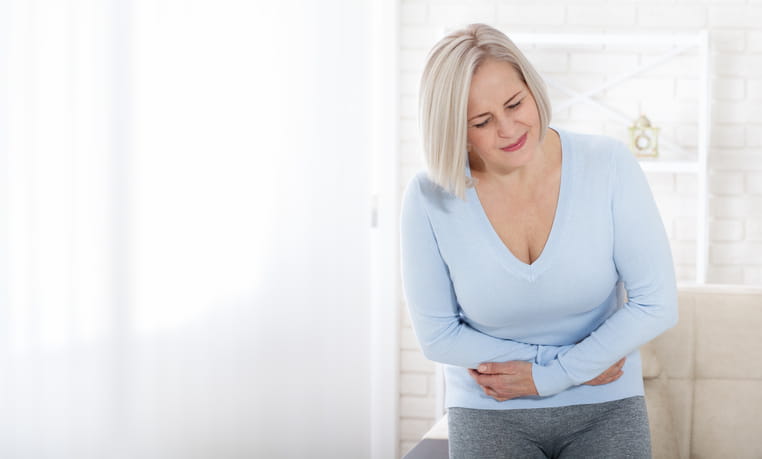 A woman clutching her stomach in pain