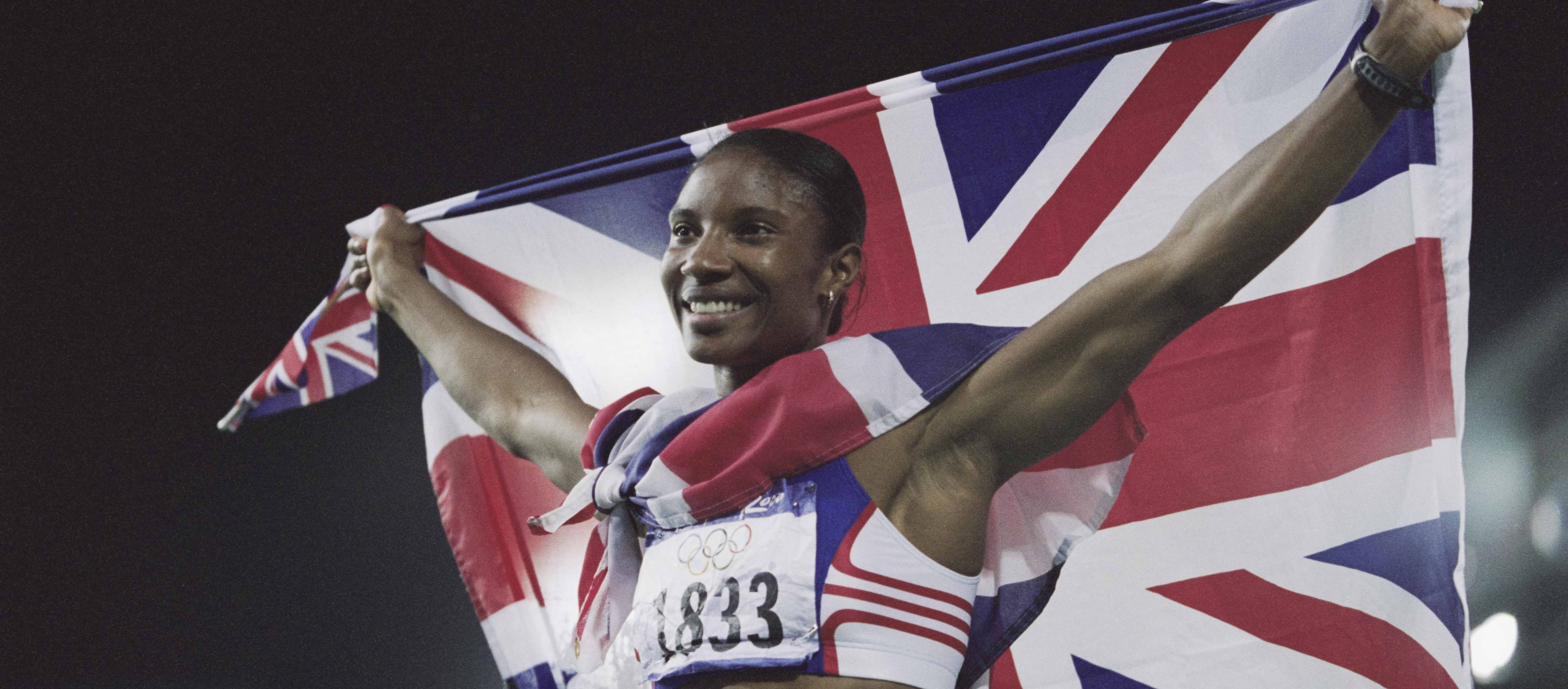 Olympian Denise Lewis holding a Union Jack flag