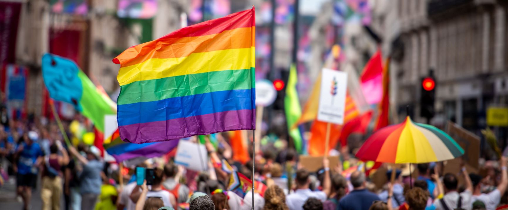Pride flags in a parade down the street