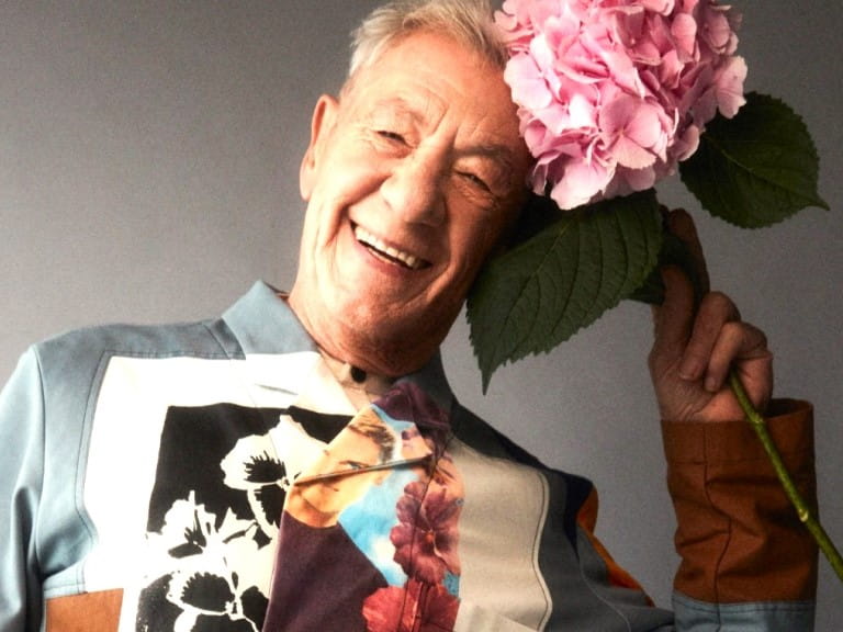 Sir Ian McKellen playfully posing with hydrangeas | Alex Bramall/Kintzing