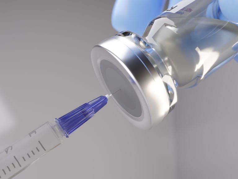 Syringe being inserted into a vaccine vial | Getty/Peter Hansen