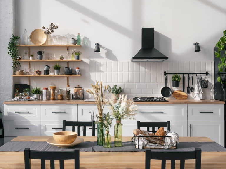 Modern Scandinavian style kitchen with neutral cupboards and open shelving
