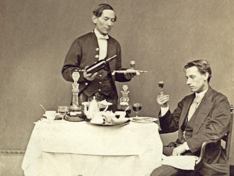Black and white photo of a sommelier serving wine | Getty Images