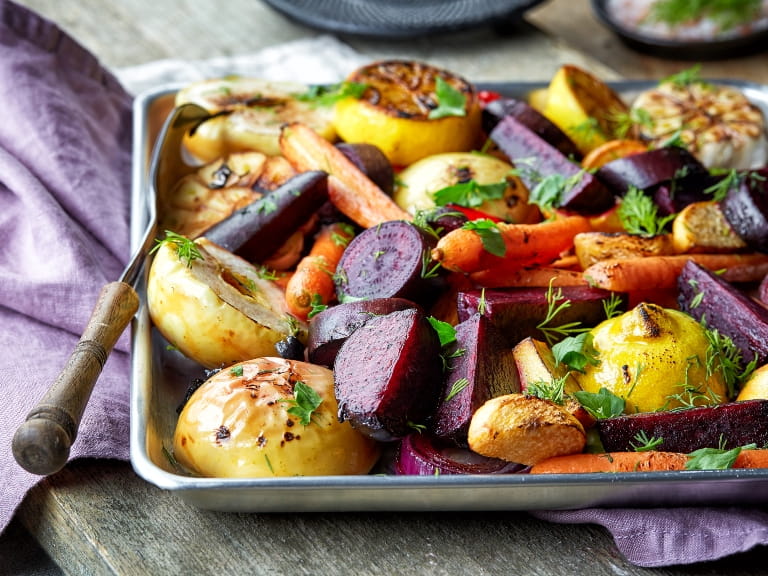 Roasted fruits and vegetables on wooden table