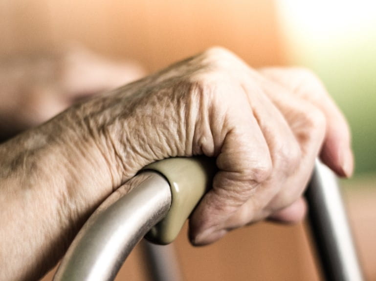 Elderly hands on a walker | Getty/sanjagrujic
