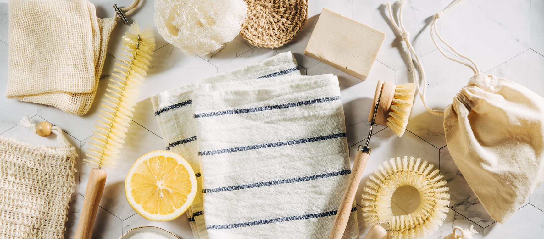 A selection of cleaning items including sponges, brushes, spray bottles and gloves