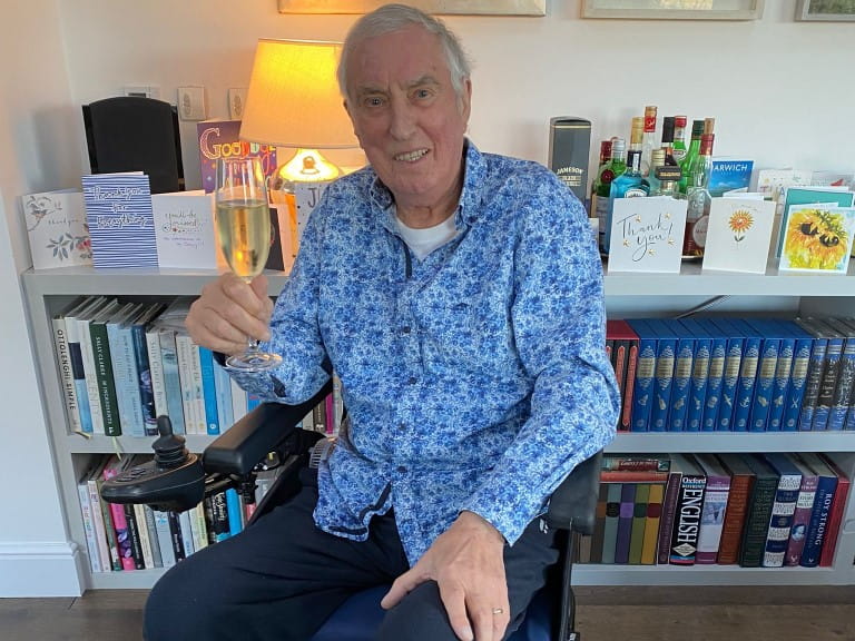 Johnnie Walker sitting down with a drink