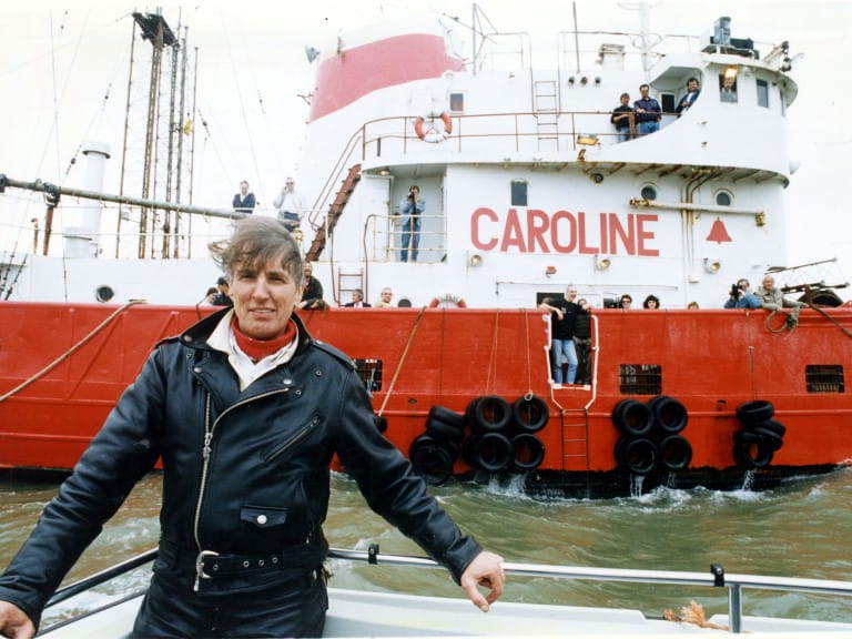 A young Johnnie Walker in front of the radio ship Caroline