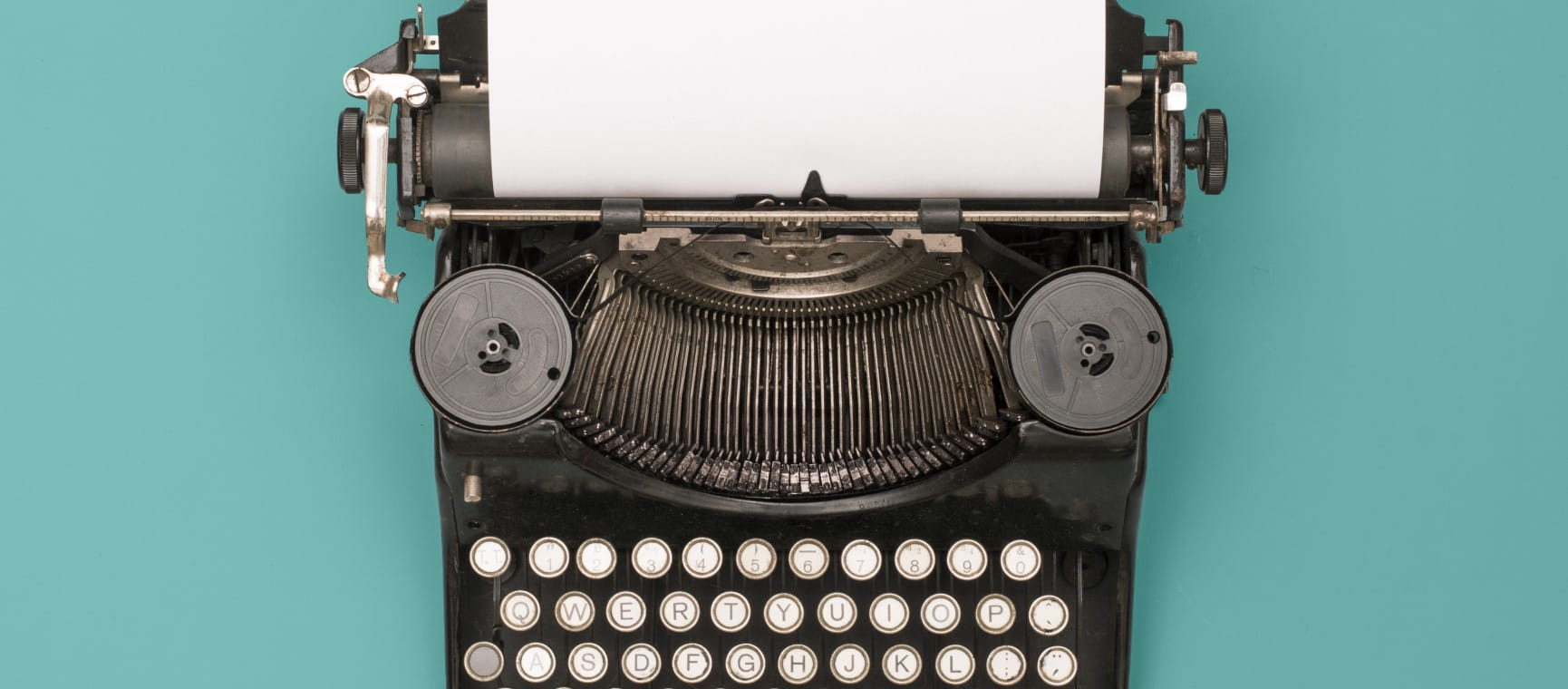 An old typewriter on a green background representing how to self publish a book | Shutterstock