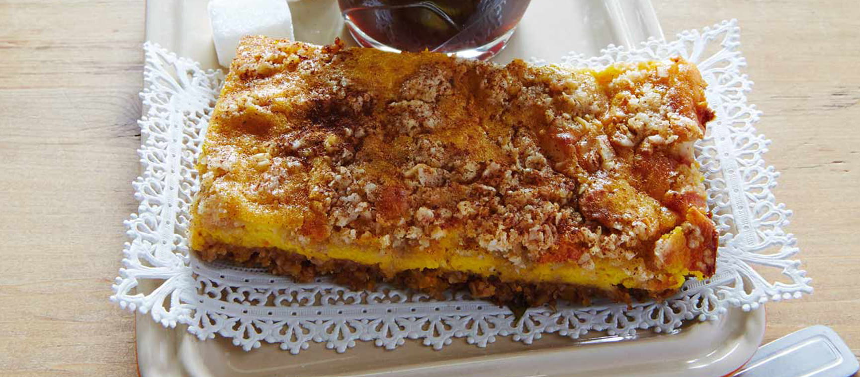 a slice of pumpkin cheesecake on a doily