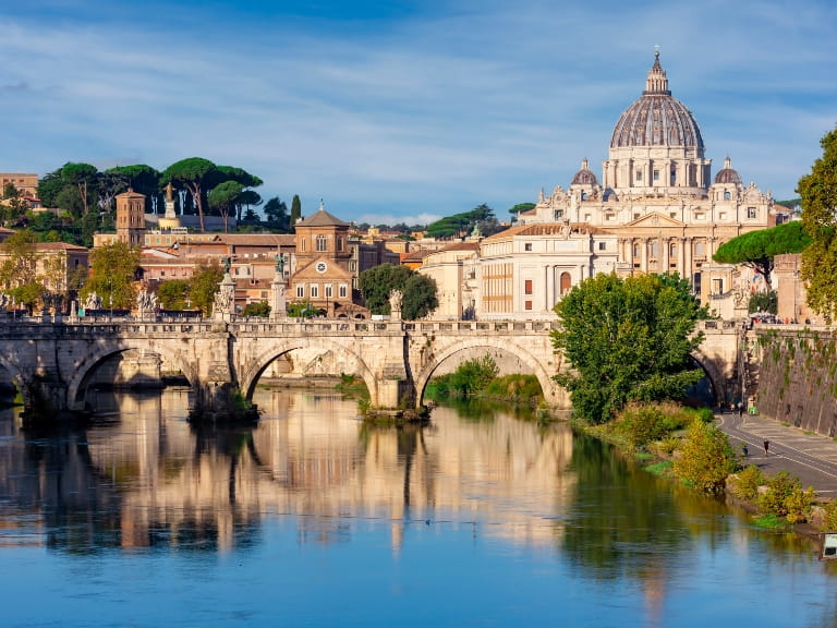 A view of St Peter's basilica in Vatican and the Victor Emmanuel II bridge in Rome, Italy on a sunny day
