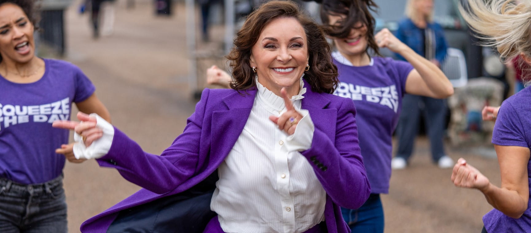 Strictly judge Shirley Ballas dancing outdoors with a group of women