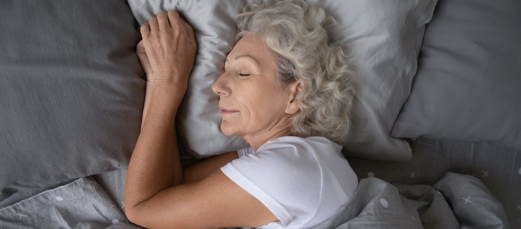 An older woman asleep in bed