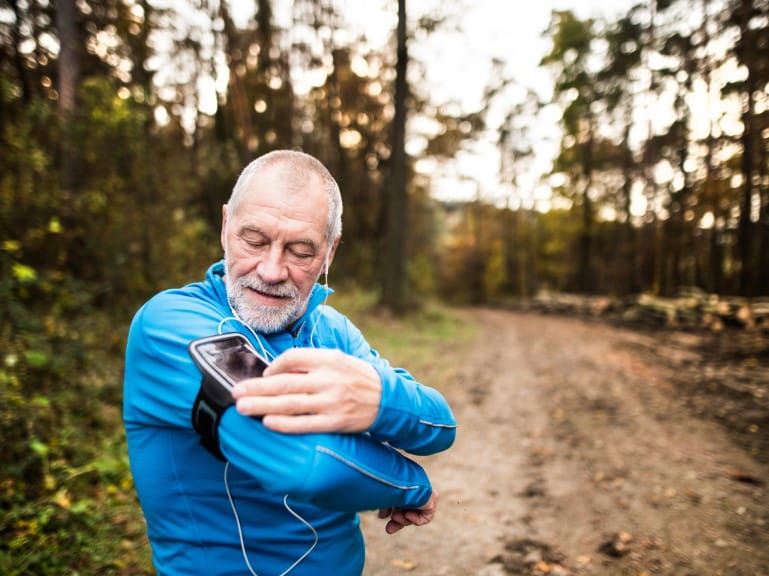 An older man prepares to go on a trail run