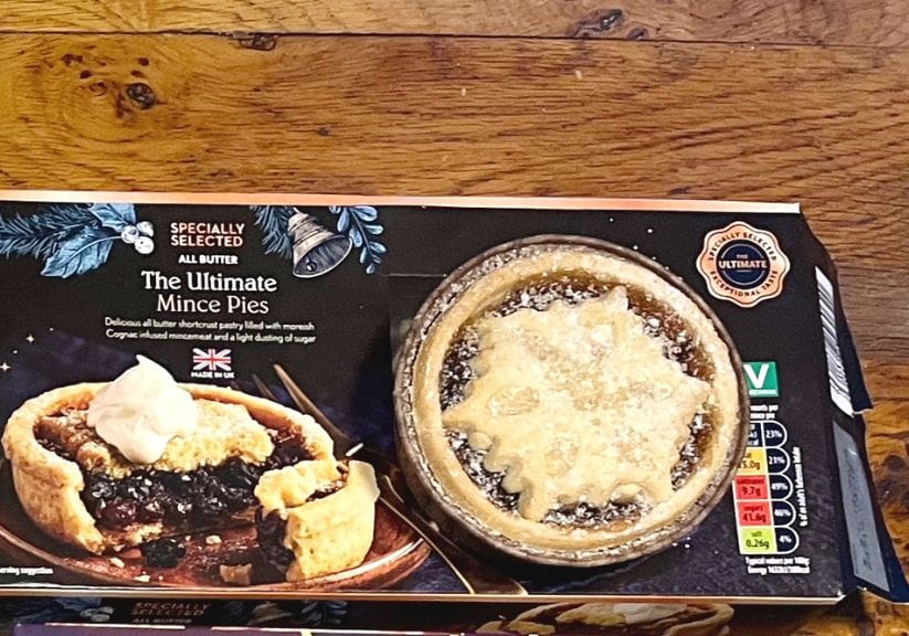 A box of Aldi Ultimate Mince Pies on a wooden table top