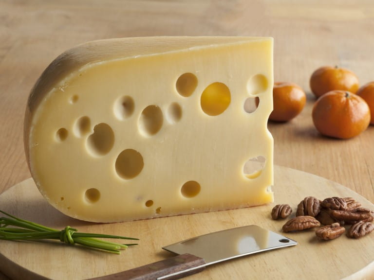 A large slice of emmenthal cheese