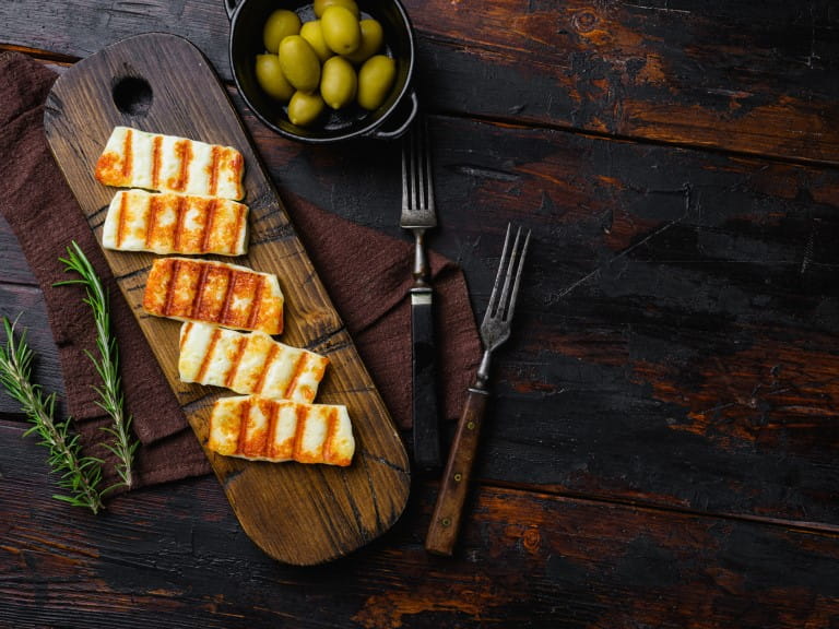 Halloumi fried cheese, on old dark wooden table