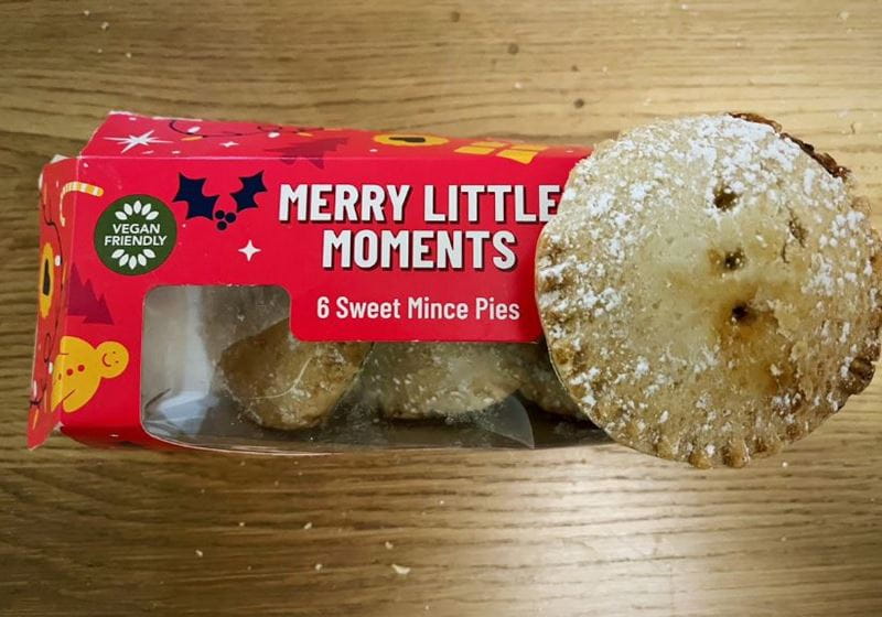 A box of Greggs mince pies on a wooden table top