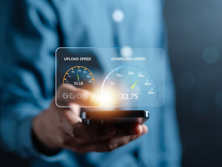 A man holding a device displaying internet speeds