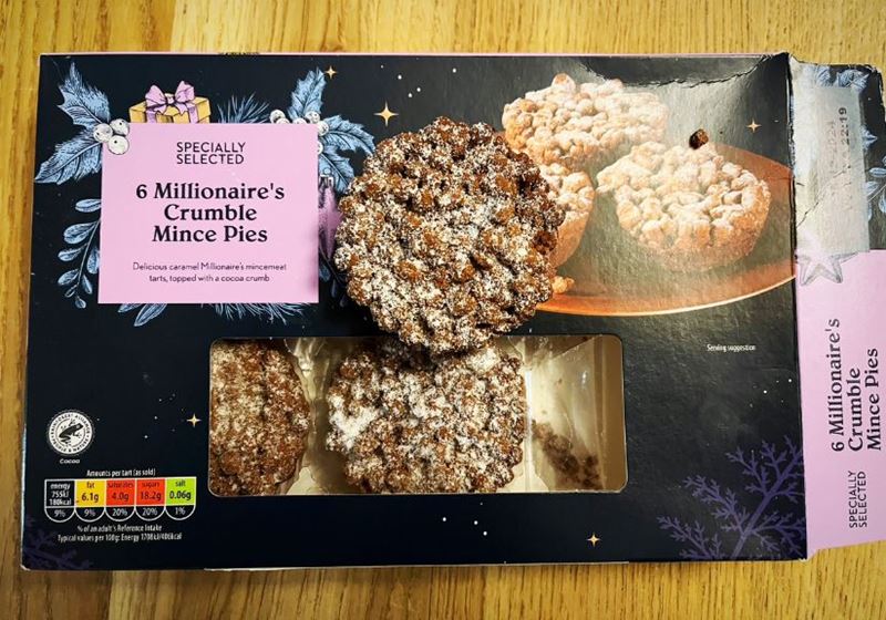 A box of Aldi Millionaires Mince Pies on a wooden table