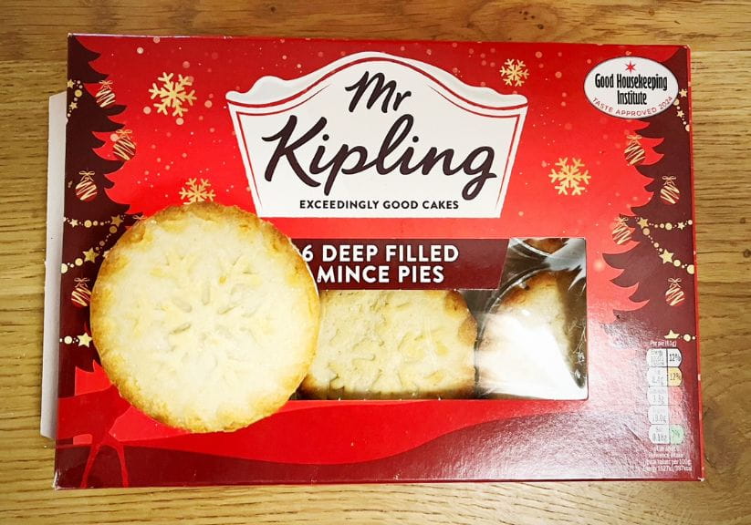 A box of mr kipling mince pies on a wooden table top