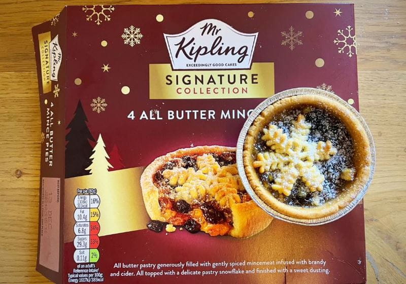 A box of Mr Kipling Signature mince pies on a wooden table