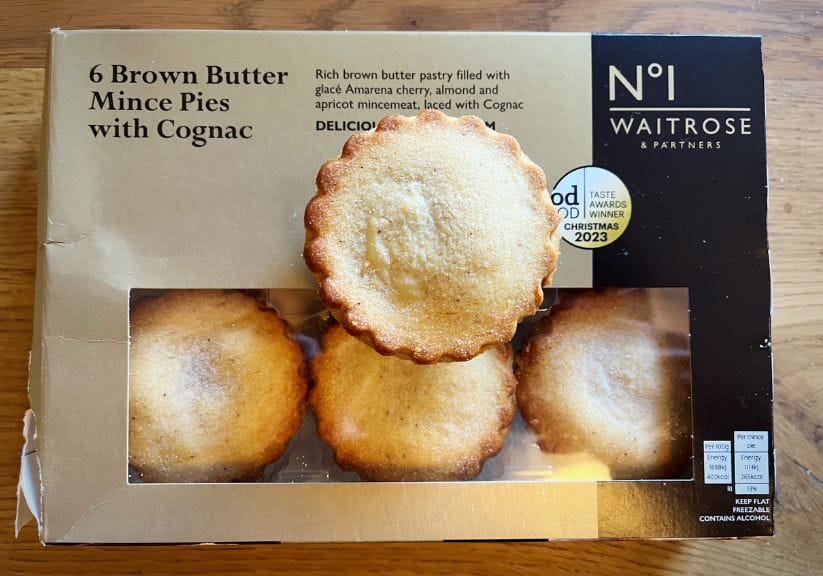a box of brown butter Waitrose mince pies on a wooden table top