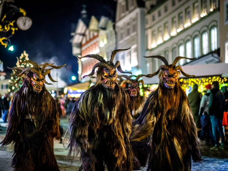 Figures dressed as Krampus at a Christmas market in Germany