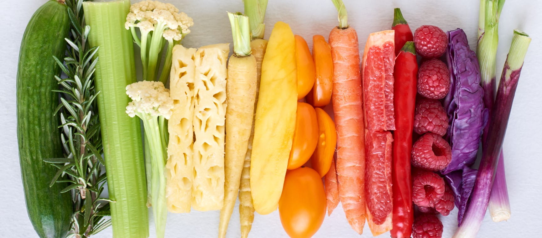 Colourful fruits and vegetables arranged in a row