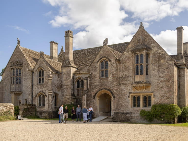The north front of Great Chalfield Manor, Wiltshire, with visitors in the courtyard