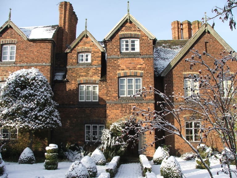 The front of Moseley Old Hall on a snowy winter day