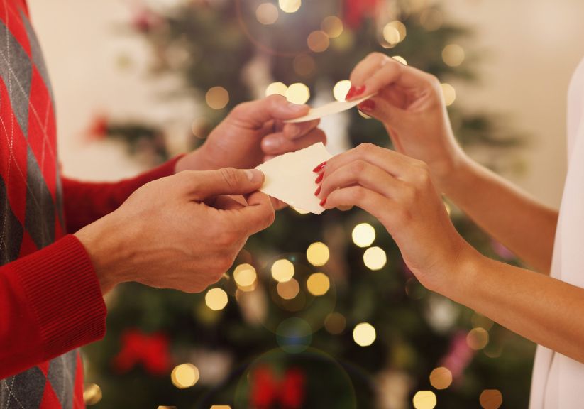 A couple breaking the traditional wafer eaten in Poland on Christmas Eve