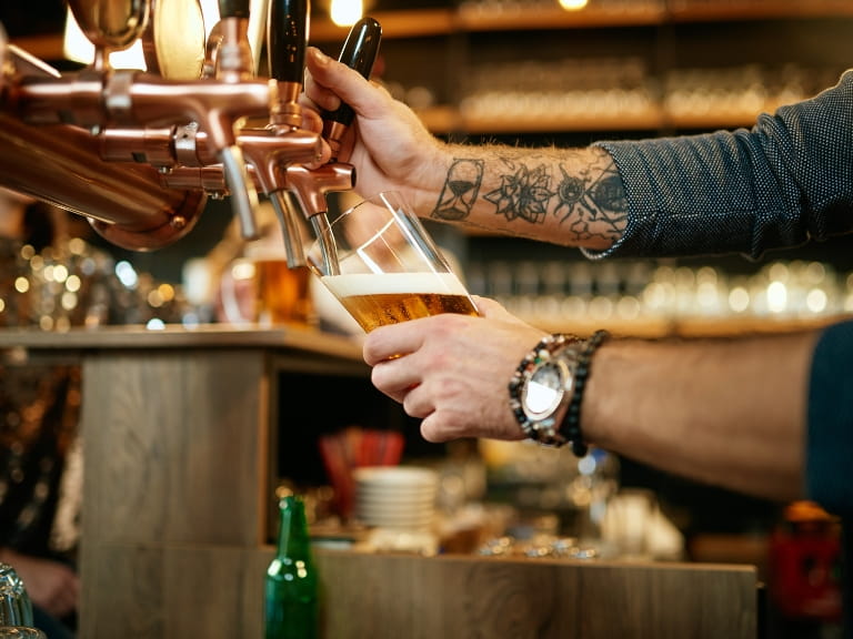 Barman pulling a pint in a pub