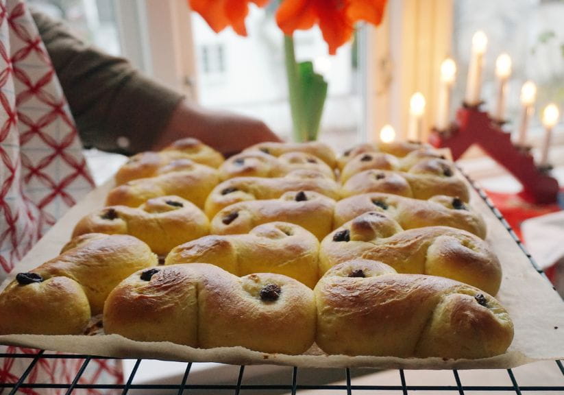 A woman with a tray of saffron buns for the festival of St Lucia in Scandinavia