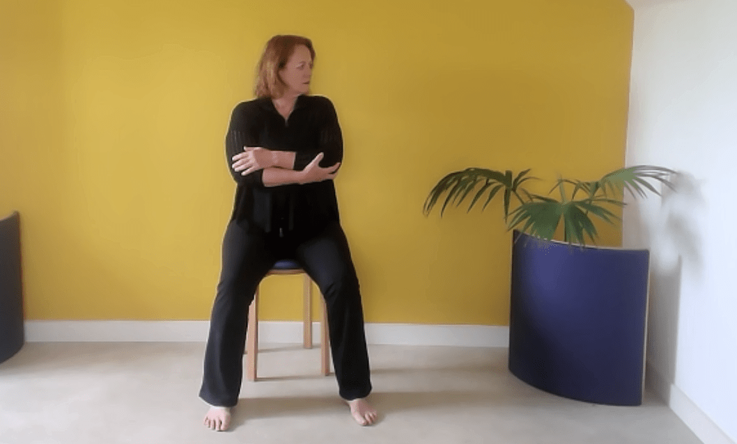 Woman moving the neck with arms supported