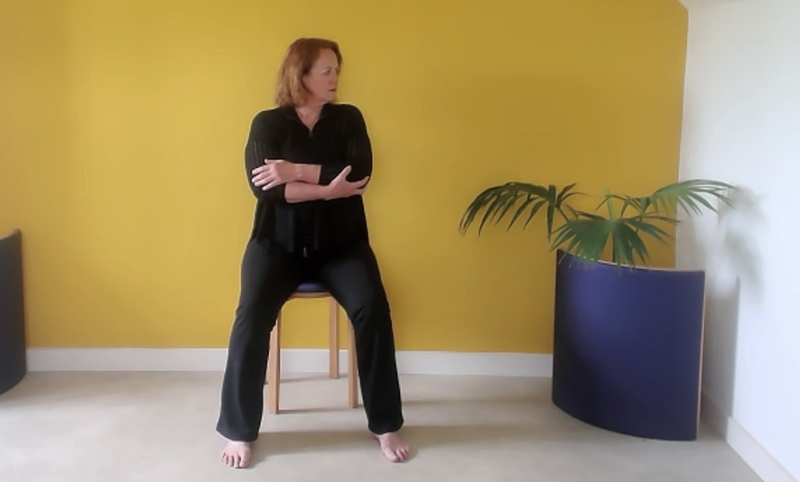 Woman moving the neck with arms supported