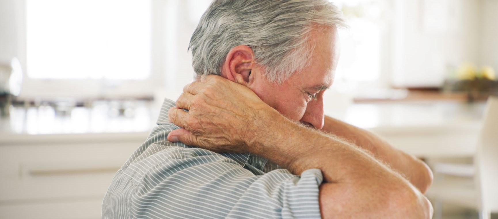 Man pulling on his neck pain