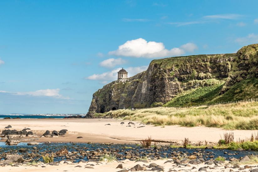 Benone Beach in Northern Ireland with the church on the cliff