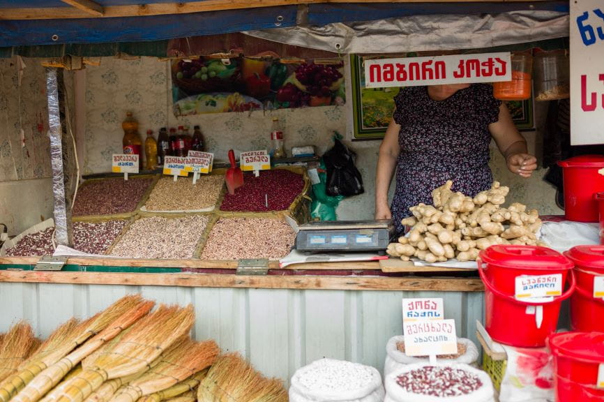 A local woman stands inside her market stall outside of Tbilisi’s Station Square at the Dezerter Bazaar