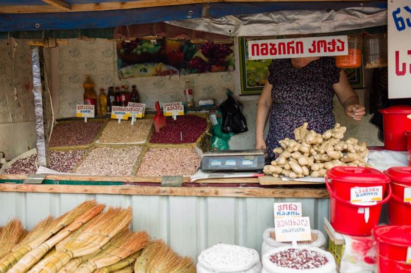 A local woman stands inside her market stall outside of Tbilisi’s Station Square at the Dezerter Bazaar